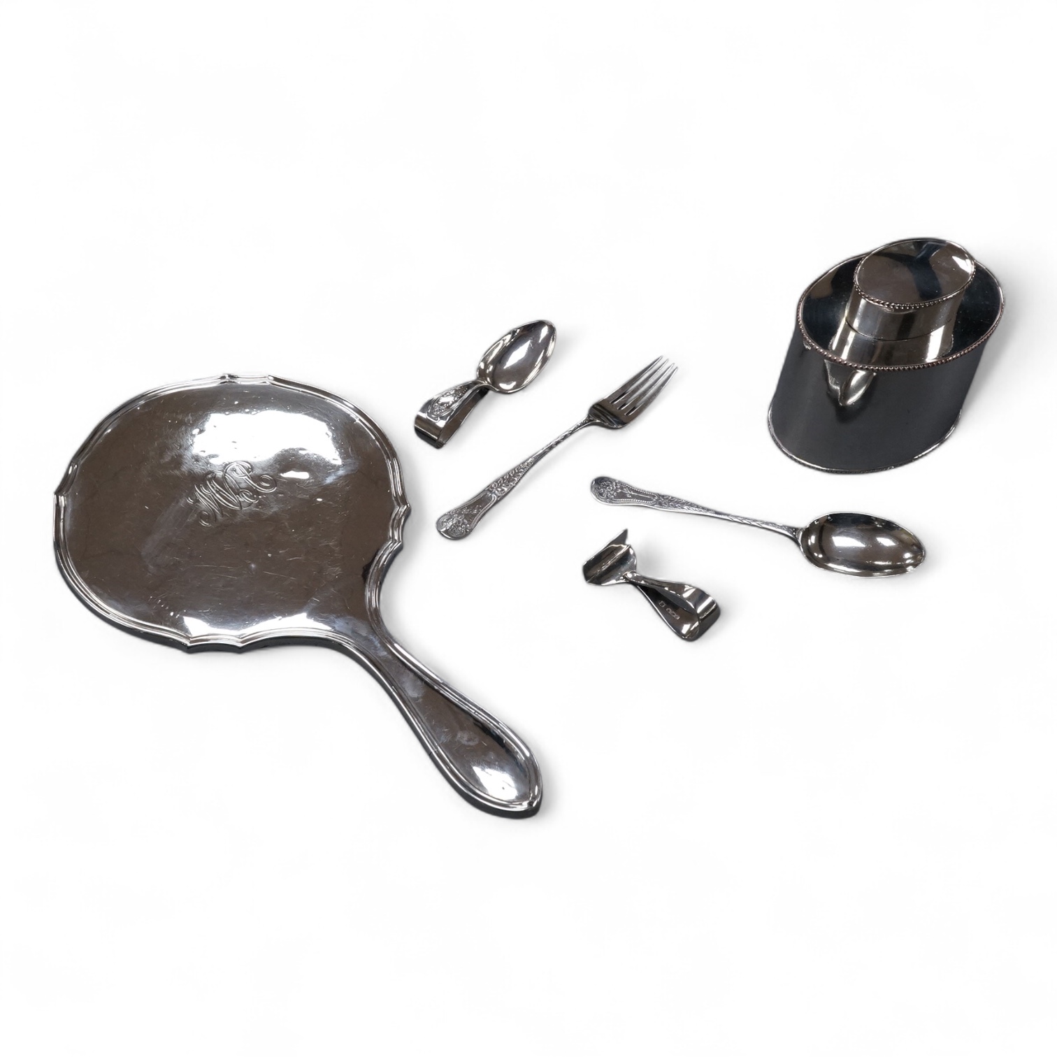 A George V silver mounted hand mirror, a silver spoons and pusher, a silver christening fork and spoon and a silver plated tea caddy.